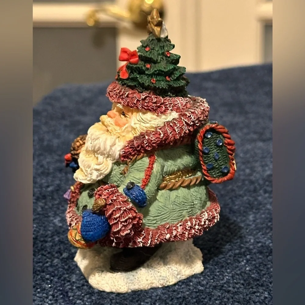 So adorable - mini Santa dressed for traveling! Wears a Christmas tree hat!